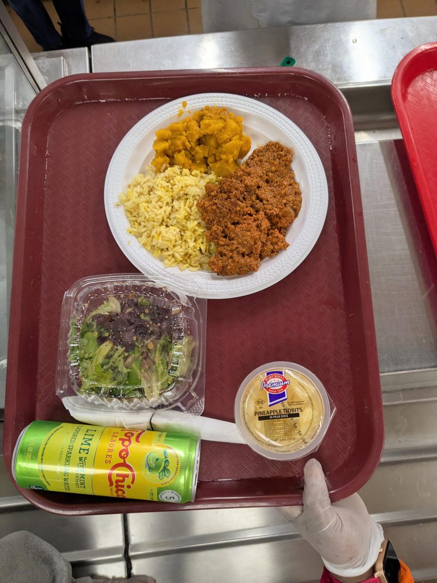 A freshly prepared tray of rice, squash, ground turkey, salad, pineapple, and sparkling water at the New York Common Pantry.